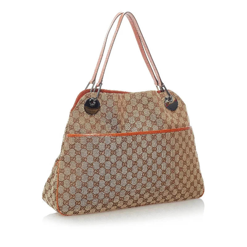 Women Gucci bags with a snap - button closure and a decorative charmGucci GG Canvas Eclipse Shoulder Bag (32048)