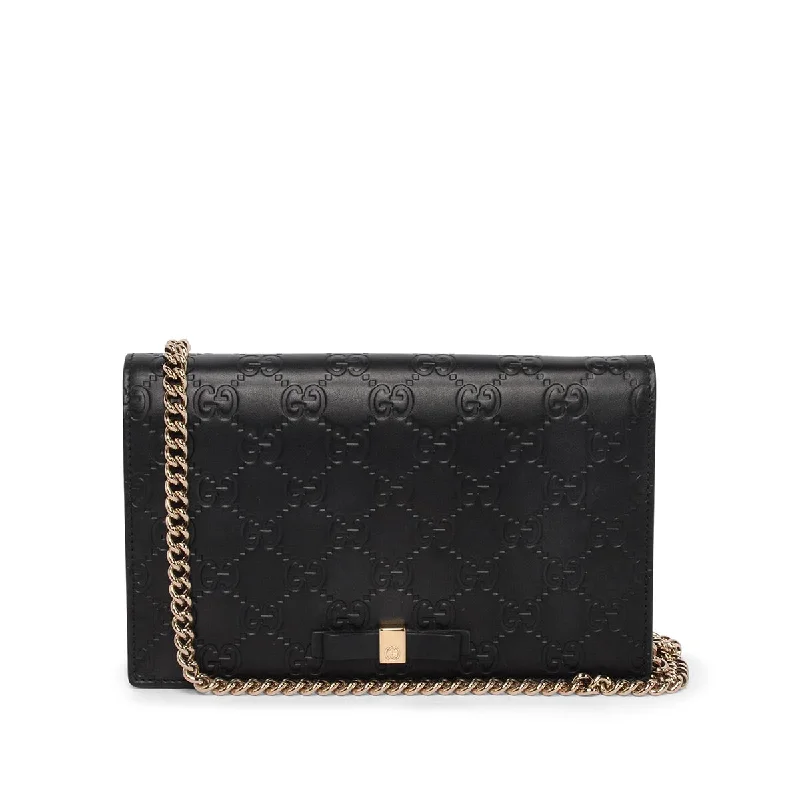 Women Gucci Sylvie bags with a monogram - embossed leatherGucci Black Guccissima Signature Bow Wallet On Chain